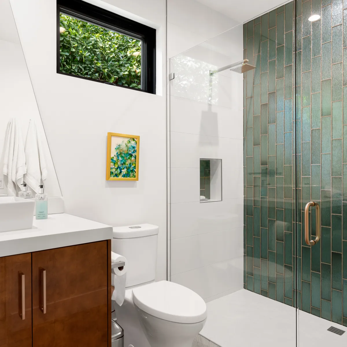 Guest bathroom with a walnut vanity, vessel sink and a walk-in shower lined in green vertical tile
